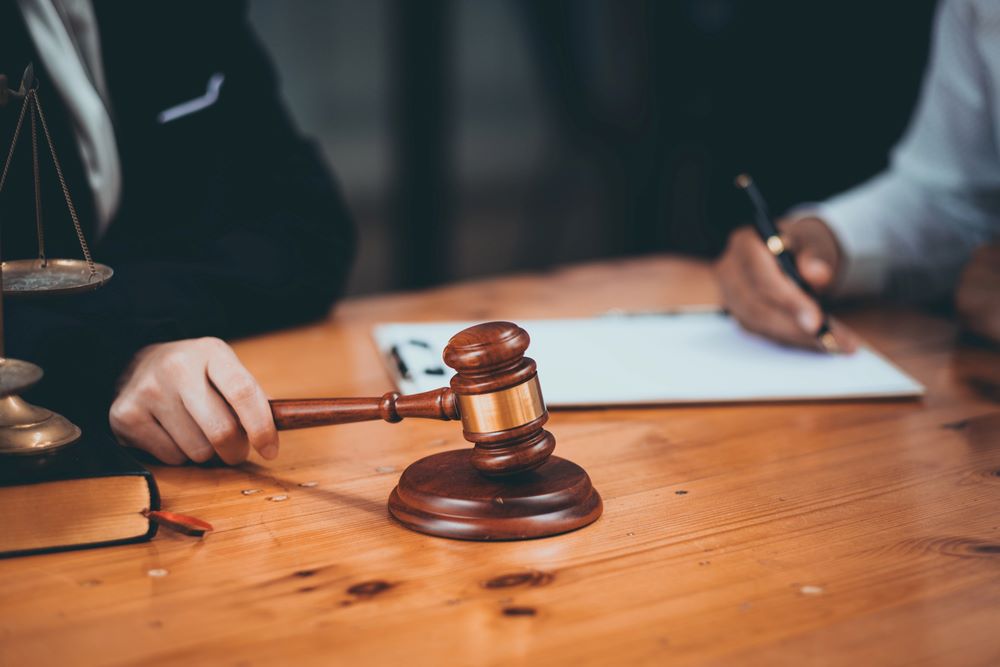 Image of a close-up of a judge's gavel on a wooden table with legal documents, featuring 411 Real Estate Law and highlighting 'Legal Representation and Advice,' ensuring it aligns with the page's context.