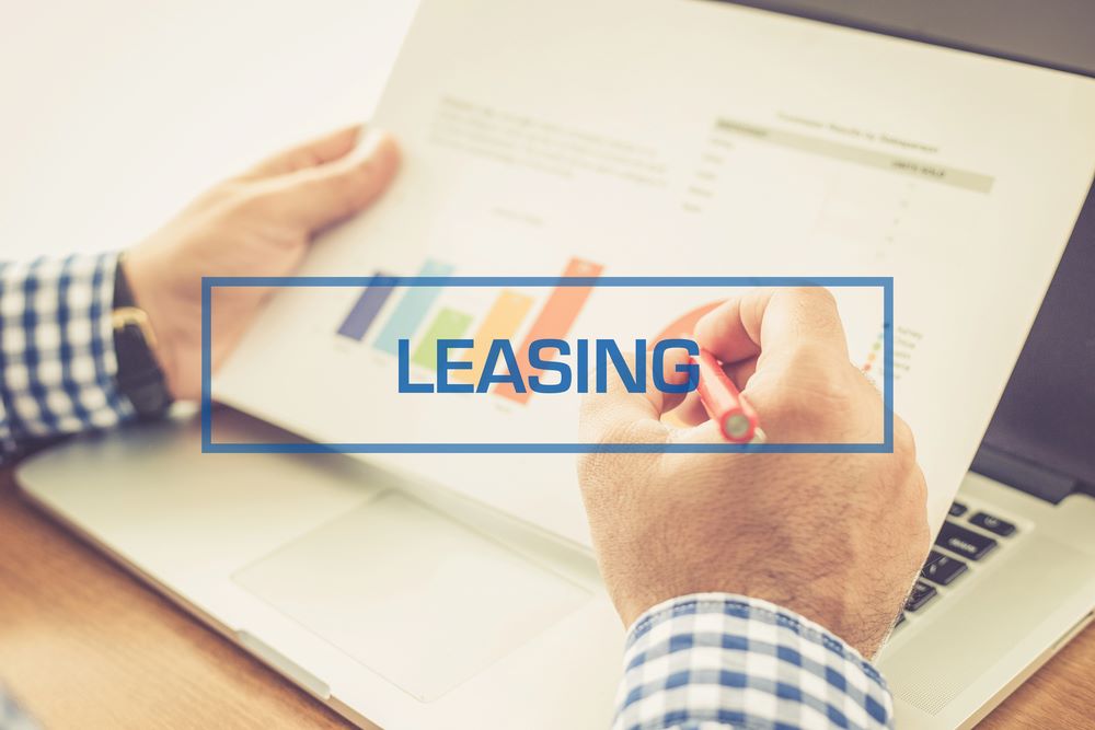 Image of a businessman holding charts, featuring 411 Real Estate Law and highlighting 'Percentage Lease and Triple Net Lease,' ensuring it aligns with the page's context.